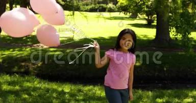 公园里的小女<strong>孩</strong>拿着气球来<strong>宣传</strong>乳腺癌